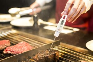 Chef Checking A Steak's Internal Temperature