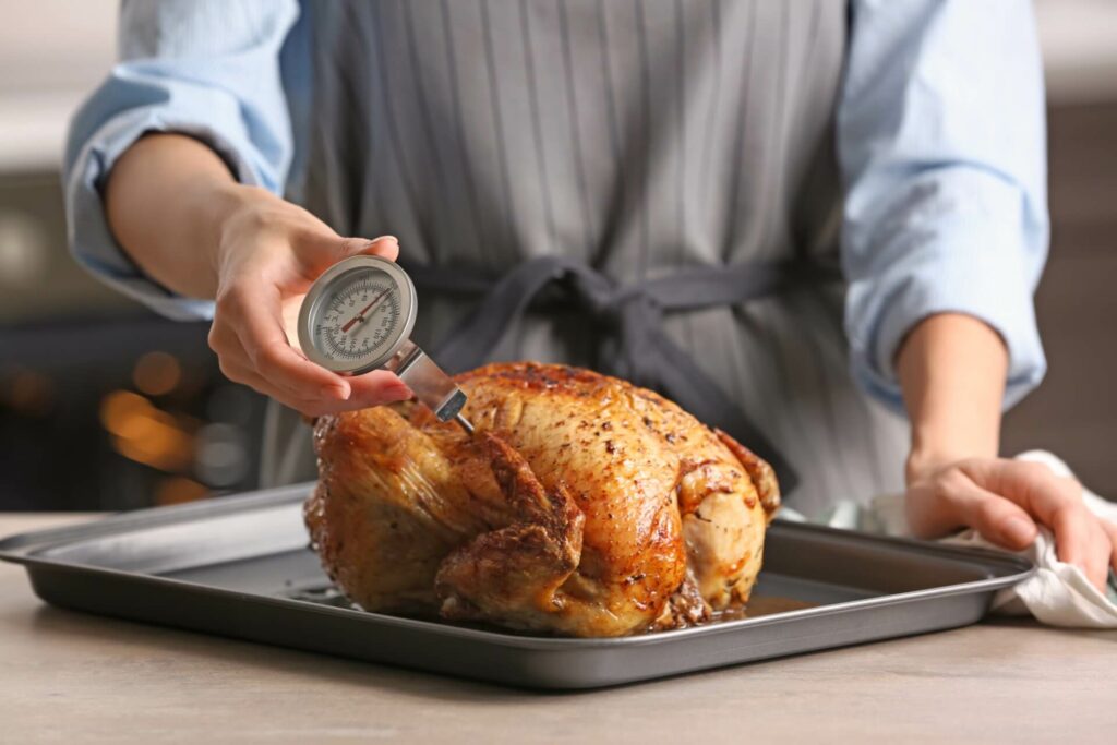 Restaurant Cook Checking The Temperature Of Chicken