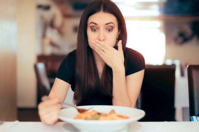 Woman In Restaurant With Food Poisoning