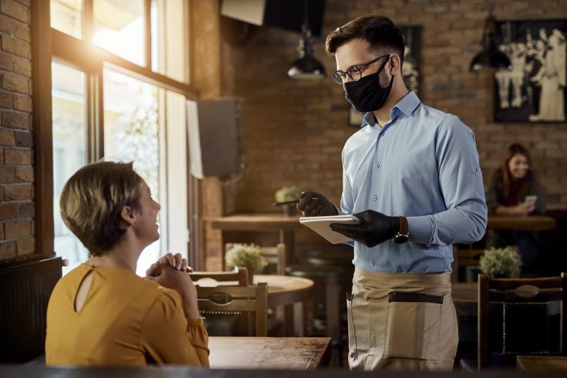 Waiter Wearing a Mask And Glove Is Being Hygienic