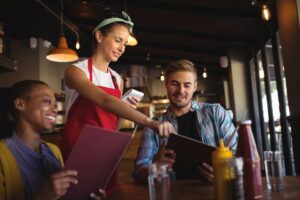 Waitress With TABC Certification Serves Customers