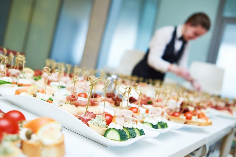 Restaurant waitress serving table with food